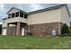 Exterior rear view with a screen porch, large lot, and brick-base vinyl siding, with a utility gas tank in the yard at 1519 Midland Dr, Hudson, NC 28658