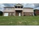 Back exterior featuring a screen porch and patio, with large lawn and brick and vinyl siding at 1519 Midland Dr, Hudson, NC 28658