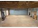 Unfinished basement featuring exposed wood ceiling, concrete floors, and insulated walls, ready for customization at 1519 Midland Dr, Hudson, NC 28658