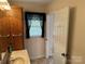 Well-lit bathroom featuring a built-in wooden cabinet and lace-trimmed window at 1519 Midland Dr, Hudson, NC 28658