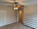 Bedroom with carpeted floors, neutral walls, closet, shelving, and a ceiling fan with lighting at 1519 Midland Dr, Hudson, NC 28658