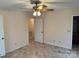 Bright bedroom featuring neutral walls, carpeted floors, and a ceiling fan with attached lighting at 1519 Midland Dr, Hudson, NC 28658
