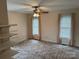 Spacious bedroom featuring two windows, neutral walls, carpeted floors, and open shelving at 1519 Midland Dr, Hudson, NC 28658