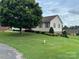View of the left side of the house with a lawn and a tree at 1519 Midland Dr, Hudson, NC 28658
