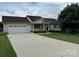 Charming ranch-style home with a well-manicured front yard and a two-car attached garage and long driveway at 1519 Midland Dr, Hudson, NC 28658