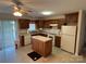Kitchen featuring wooden cabinets, laminate countertop, a center island, and a ceiling fan at 1519 Midland Dr, Hudson, NC 28658