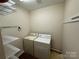 Well-lit laundry room featuring a washer, dryer, and ample shelving for storage at 1519 Midland Dr, Hudson, NC 28658