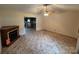 Living room with a decorative fireplace leading into the kitchen space at 1519 Midland Dr, Hudson, NC 28658