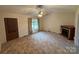 Cozy living room with a ceiling fan, window and a decorative fireplace at 1519 Midland Dr, Hudson, NC 28658