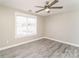 Bright bedroom with a modern ceiling fan, light gray walls, and wood-look floors for a clean, contemporary style at 1522 Tuckers Glenn Dr, Rock Hill, SC 29732