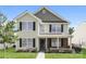 Inviting two-story house with a combination of neutral siding and brick accents, complemented by lush green grass at 1522 Tuckers Glenn Dr, Rock Hill, SC 29732