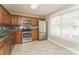 Well-lit kitchen featuring stainless steel appliances, granite countertops, and warm wood cabinets with a tiled backsplash at 1522 Tuckers Glenn Dr, Rock Hill, SC 29732