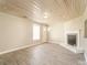 Bright living room featuring a modern fireplace, light wood flooring, and a unique wood plank ceiling at 1522 Tuckers Glenn Dr, Rock Hill, SC 29732