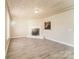 Bright living room featuring a modern fireplace, light wood flooring, and a unique wood plank ceiling at 1522 Tuckers Glenn Dr, Rock Hill, SC 29732