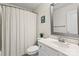 Clean bathroom with white vanity, neutral shower curtain, and framed mirror over the sink at 1800 Robbins Meadows Dr, Waxhaw, NC 28173