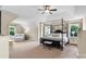 Spacious main bedroom with canopy bed, sitting area, and plenty of natural light from large windows at 1800 Robbins Meadows Dr, Waxhaw, NC 28173