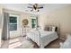 Bright bedroom with modern decor, large window, comfy bed, and accent furniture at 1800 Robbins Meadows Dr, Waxhaw, NC 28173
