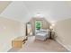 Relaxing bedroom with an accent chair, natural light and neutral tones for a peaceful retreat at 1800 Robbins Meadows Dr, Waxhaw, NC 28173