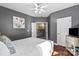 Bedroom with gray walls, hardwood floors, and a glimpse into the living room adds depth at 1800 Robbins Meadows Dr, Waxhaw, NC 28173