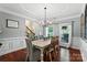Dining area featuring a trey ceiling, decorative wall trim, a chandelier and views of the entryway and front yard at 1800 Robbins Meadows Dr, Waxhaw, NC 28173
