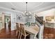 Formal dining room with hardwood floors, trey ceiling, decorative lighting, and an open entry at 1800 Robbins Meadows Dr, Waxhaw, NC 28173