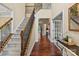 Elegant entryway showcasing hardwood floors, a staircase with iron spindles, and a view into other rooms at 1800 Robbins Meadows Dr, Waxhaw, NC 28173