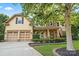 Inviting two-story house boasts lush landscaping, a stone facade, and a spacious two-car garage at 1800 Robbins Meadows Dr, Waxhaw, NC 28173