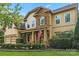 Beautiful two-story home with a stone facade, a manicured lawn, and an inviting front porch at 1800 Robbins Meadows Dr, Waxhaw, NC 28173