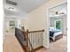 Second-floor hallway leading to a bedroom with natural light and neutral decor at 1800 Robbins Meadows Dr, Waxhaw, NC 28173