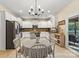Open kitchen with white cabinetry, stainless appliances, granite countertops, and eat in dining area at 1800 Robbins Meadows Dr, Waxhaw, NC 28173