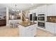 Modern kitchen features stainless steel appliances, a granite island, and an adjacent dining area at 1800 Robbins Meadows Dr, Waxhaw, NC 28173