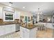 Bright eat-in kitchen featuring an island, breakfast nook, stainless steel appliances, and white cabinetry at 1800 Robbins Meadows Dr, Waxhaw, NC 28173