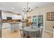 Inviting kitchen with a large island, white cabinets, stainless steel appliances and backyard access at 1800 Robbins Meadows Dr, Waxhaw, NC 28173