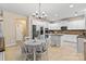 Charming eat-in kitchen offers stainless steel appliances, white cabinetry, and a central island for dining at 1800 Robbins Meadows Dr, Waxhaw, NC 28173