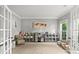 Bright playroom with neutral carpet, featuring French doors and shelving for toys and books at 1800 Robbins Meadows Dr, Waxhaw, NC 28173