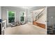 Cozy playroom with dual windows, comfortable chairs and a peek into the stairway at 1800 Robbins Meadows Dr, Waxhaw, NC 28173