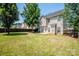 Large backyard with a patio, grass, and a wood fence at 198 Devon Forest Dr, Mooresville, NC 28115