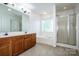 Bathroom featuring a double vanity, soaking tub, and a glass enclosed shower at 198 Devon Forest Dr, Mooresville, NC 28115