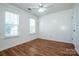 Bedroom featuring hardwood floors, white walls, a ceiling fan, and natural light at 198 Devon Forest Dr, Mooresville, NC 28115