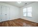 Bedroom with hardwood floors, double closet, and a window at 198 Devon Forest Dr, Mooresville, NC 28115