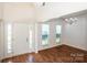 Bright foyer with hardwood floors and high ceilings leading into a dining area with chandelier at 198 Devon Forest Dr, Mooresville, NC 28115