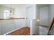 Bright hallway with hardwood floors, chandelier, and white banister at 198 Devon Forest Dr, Mooresville, NC 28115