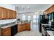 Functional kitchen featuring black appliances, oak cabinets and an open breakfast nook at 198 Devon Forest Dr, Mooresville, NC 28115
