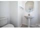 Cozy powder room with pedestal sink and neutral decor at 198 Devon Forest Dr, Mooresville, NC 28115