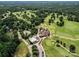 Beautiful aerial view of golf course, swimming pool, clubhouse, and manicured greens in a lush setting at 2104 Stoneyridge Dr, Charlotte, NC 28214