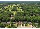 Aerial view of homes along a street, backed by a golf course and lush green trees at 2104 Stoneyridge Dr, Charlotte, NC 28214