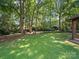 Spacious backyard of this house features mature trees, lawn, and outdoor space at 2104 Stoneyridge Dr, Charlotte, NC 28214