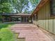 This home has a brick patio with a screened-in porch and a well-maintained lawn at 2104 Stoneyridge Dr, Charlotte, NC 28214