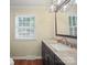Bathroom featuring dark vanity, granite countertop and wood flooring at 2104 Stoneyridge Dr, Charlotte, NC 28214