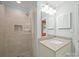 Modern bathroom with a glass shower, a window inside the shower, and a granite-topped vanity at 2104 Stoneyridge Dr, Charlotte, NC 28214